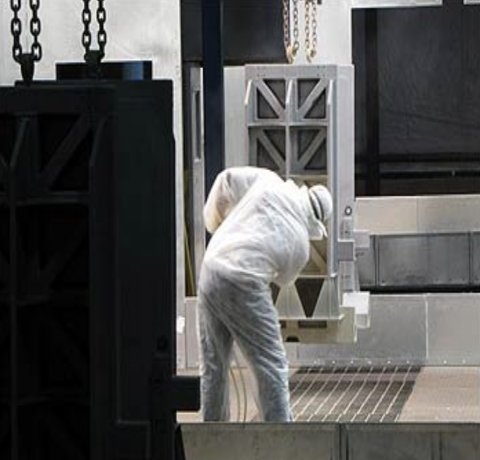 An employee of United Plating painting, using primer and top coat at a United Plating facility